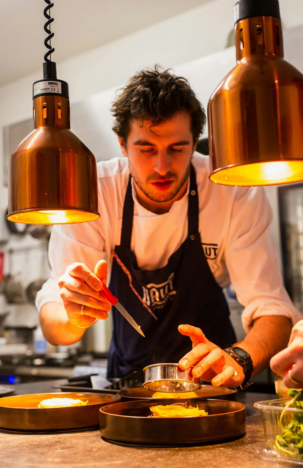 A caterer plating a course